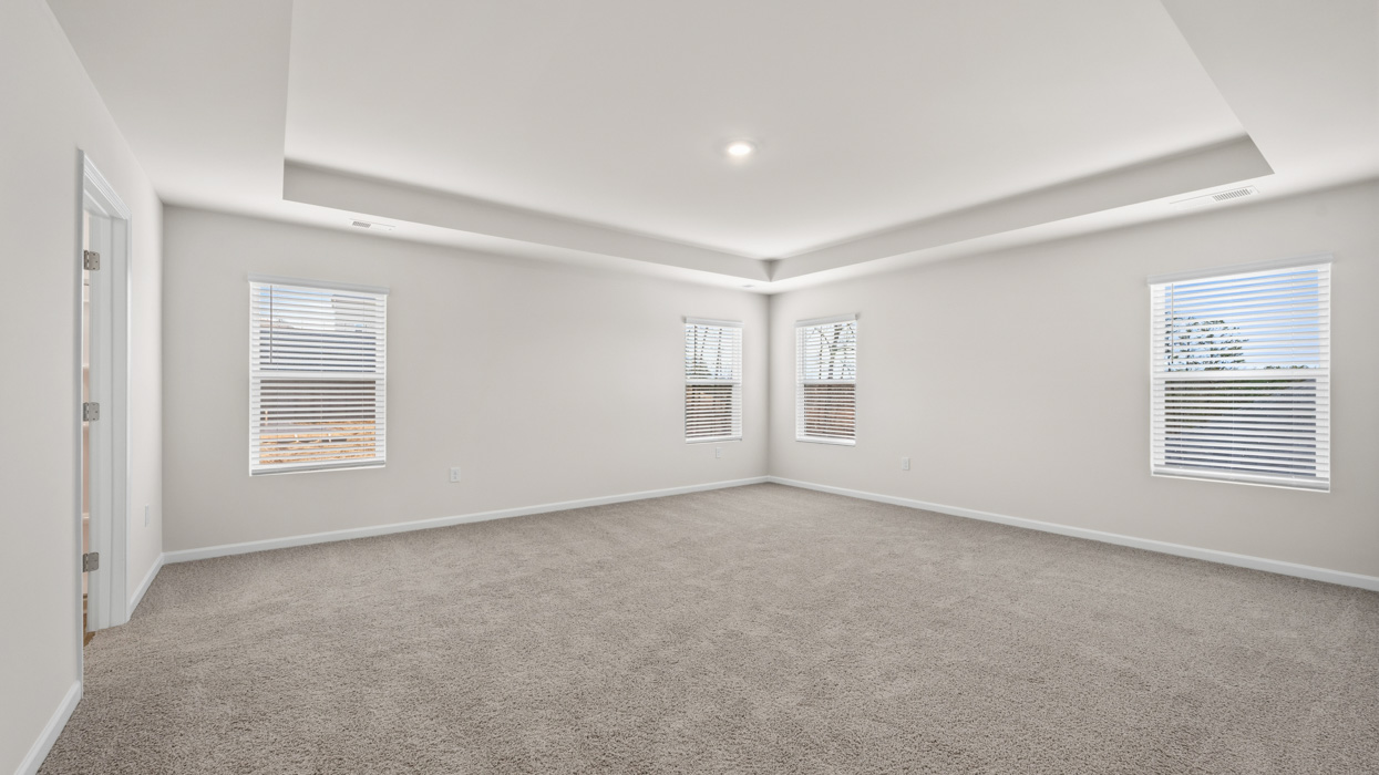 angle primary bedroom with abundance of natural light