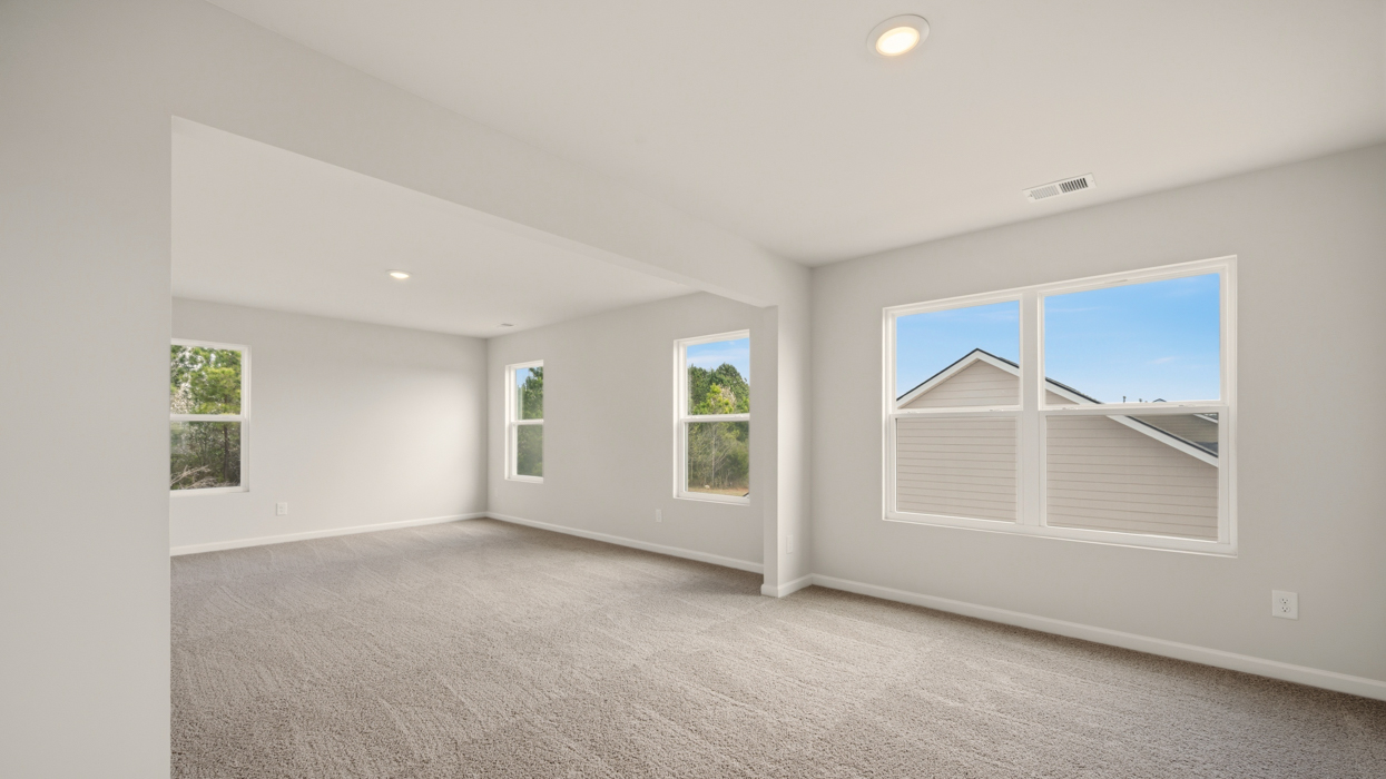 angled primary bedroom with abundance of natural light