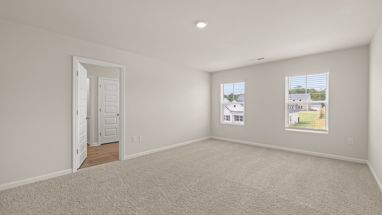 angled primary bedroom with natural light