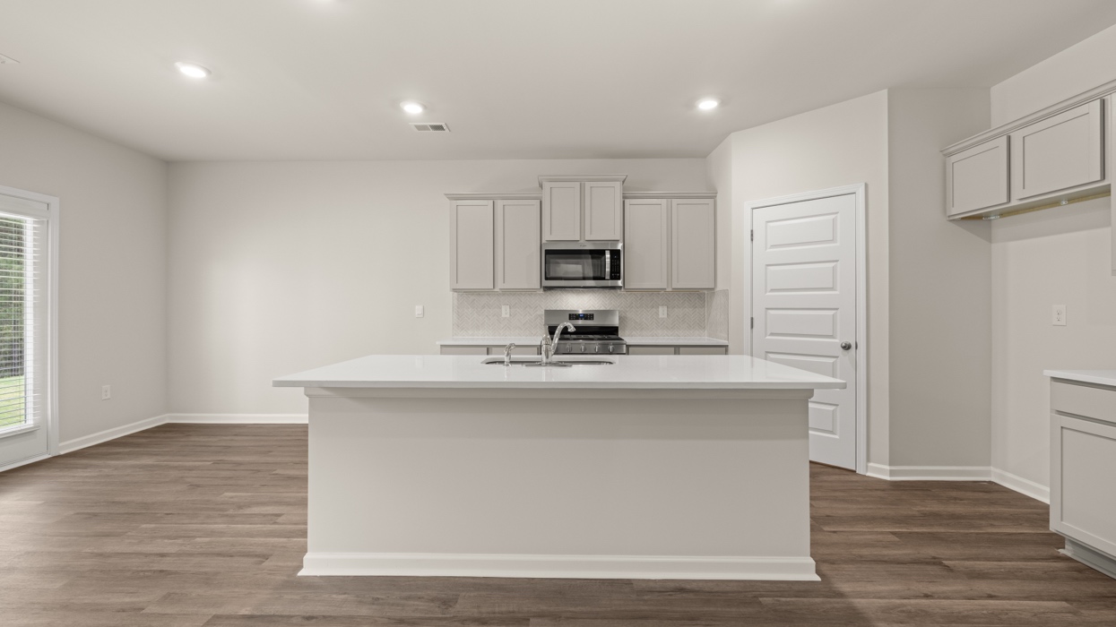 kitchen with large center island with spacious gray cabinetry