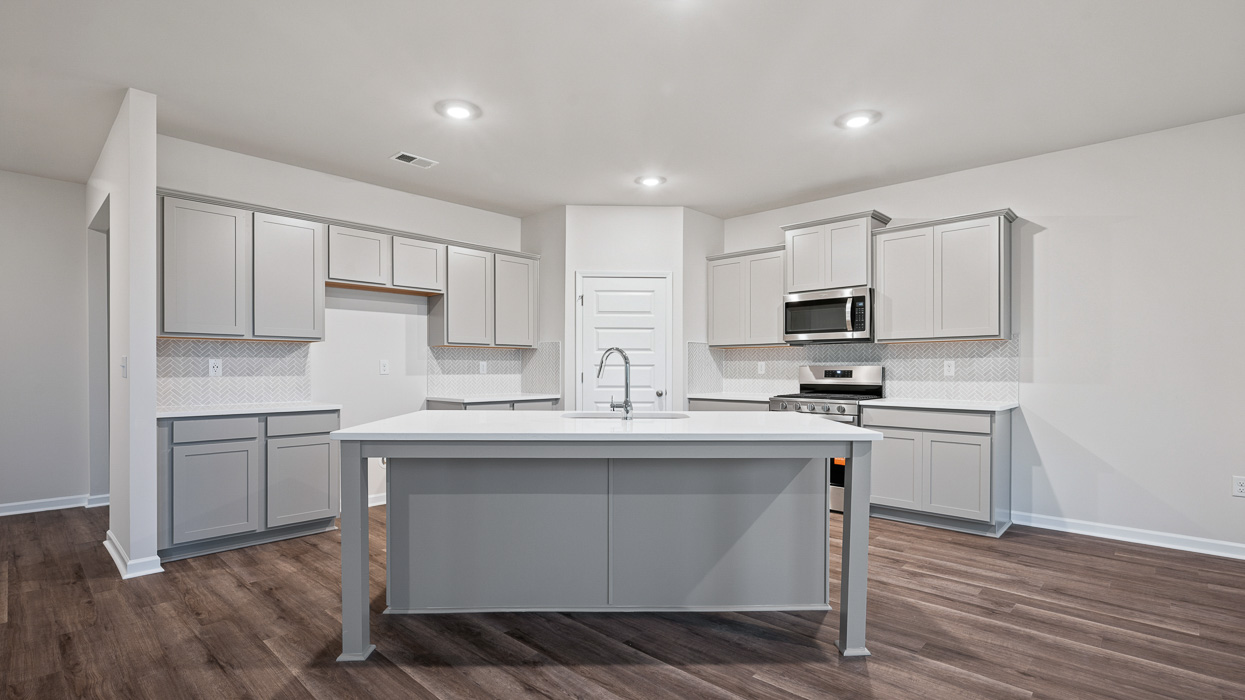 kitchen with spacious gray cabinetry and large center island