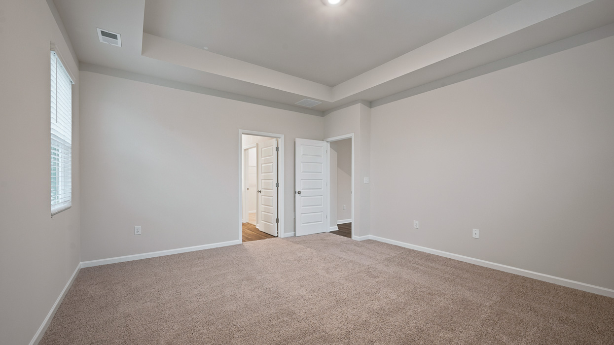 angled primary bedroom with abundance of natural light
