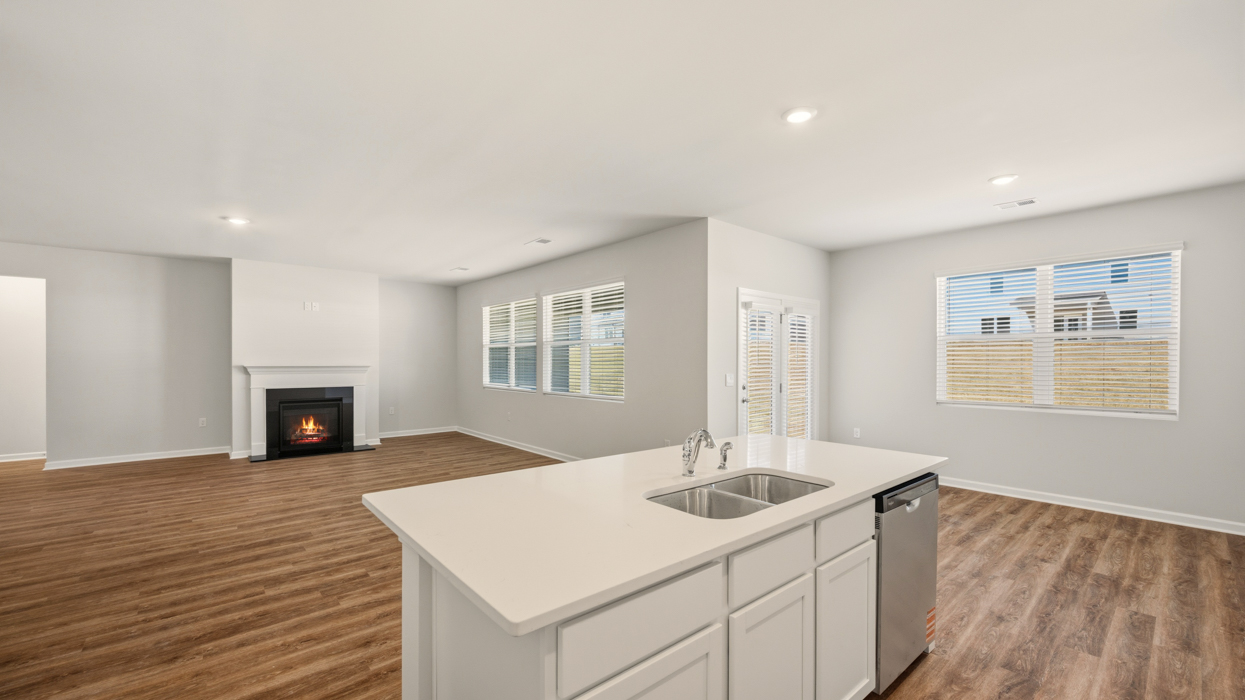 angled kitchen with large center island and natural lighting