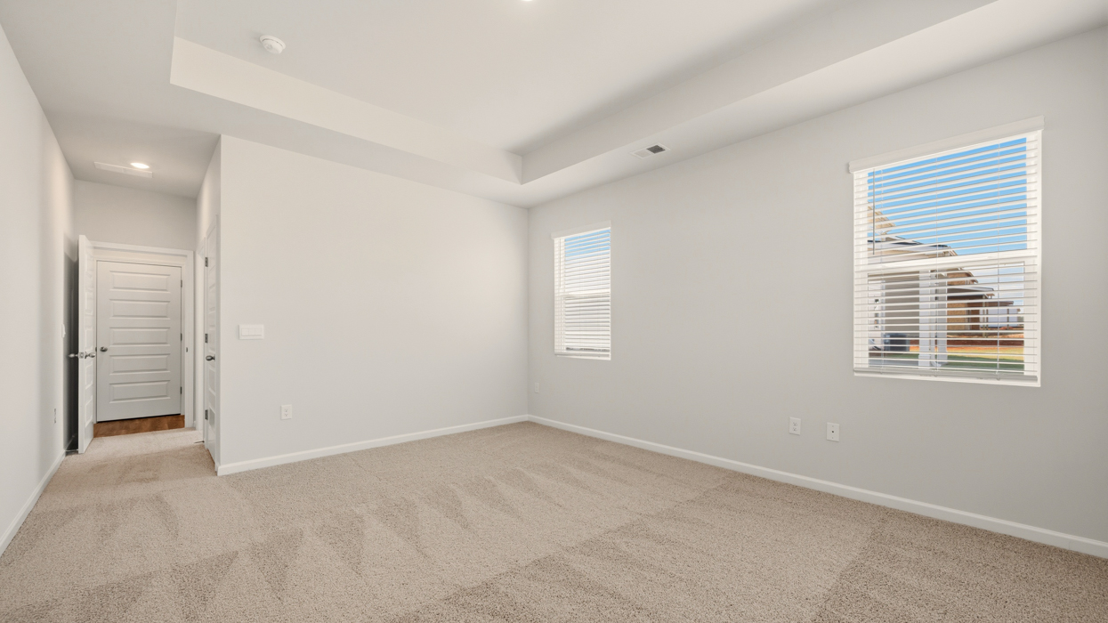 angled primary bedroom with natural lighting