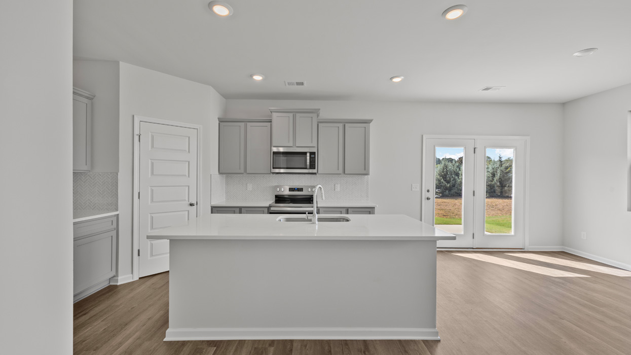 kitchen with spacious gray cabinetry and large center island