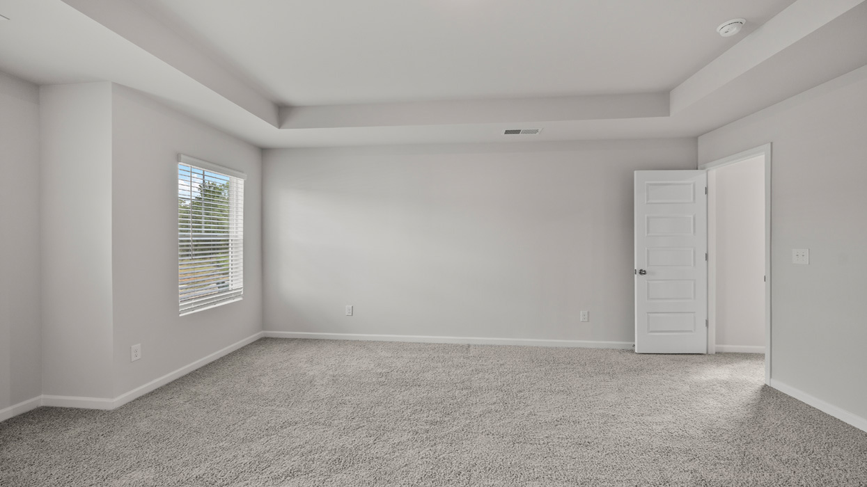 angled primary bedroom with natural light