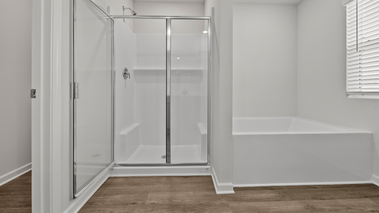 primary bathroom with walk-in shower and tub