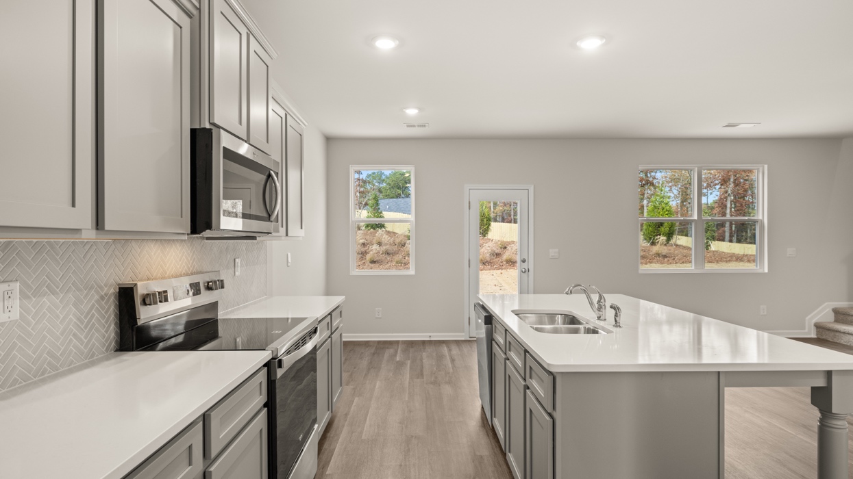 kitchen with large center island and spacious gray cabinetry