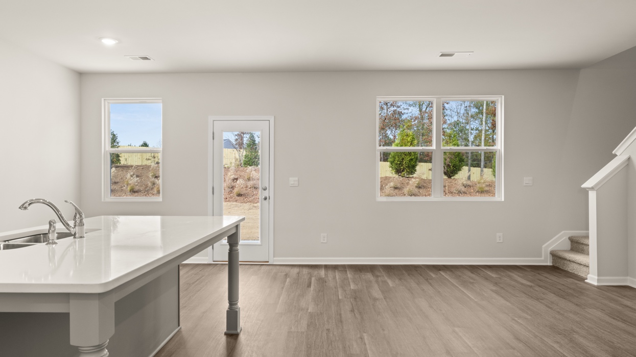 breakfast and living rooms from kitchen with abundance of natural light