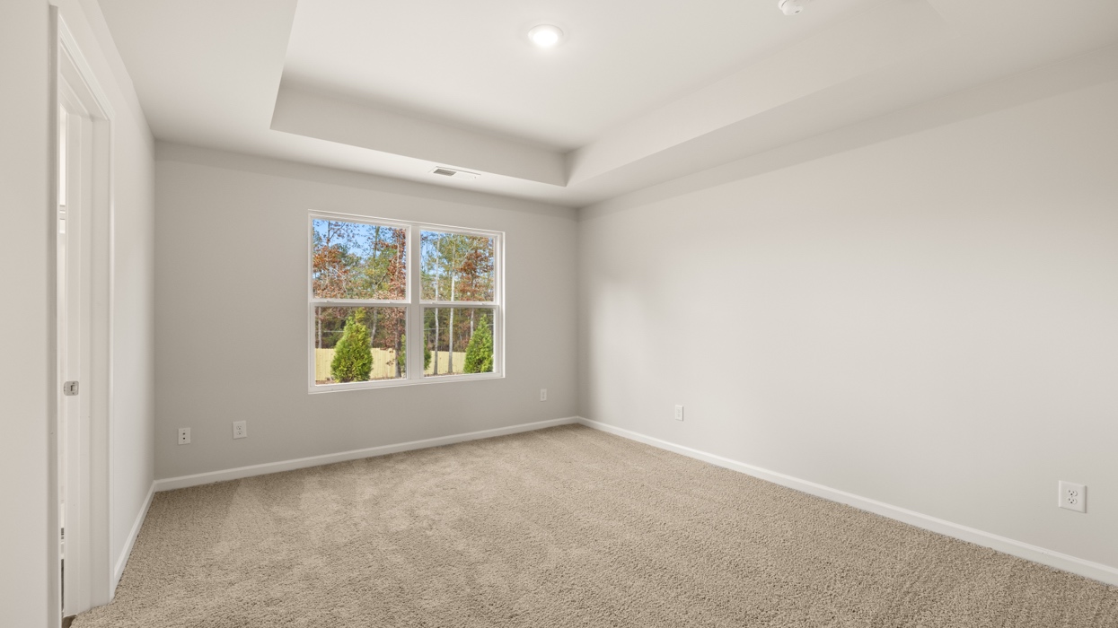 angled primary bedroom with natural light