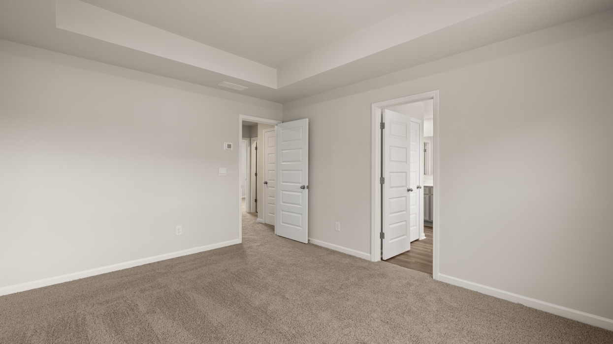 angled primary bedroom with natural light