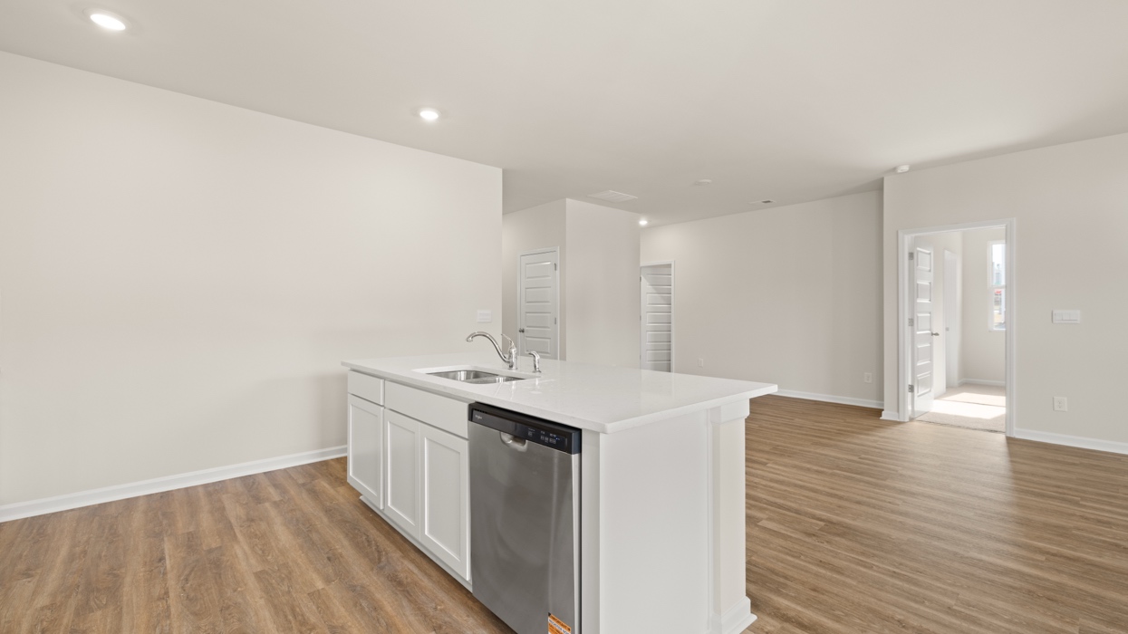 angled kitchen with spacious white cabinetry and large center island