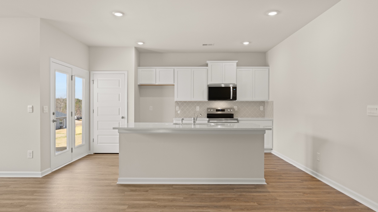 kitchen with spacious white cabinetry and large center island