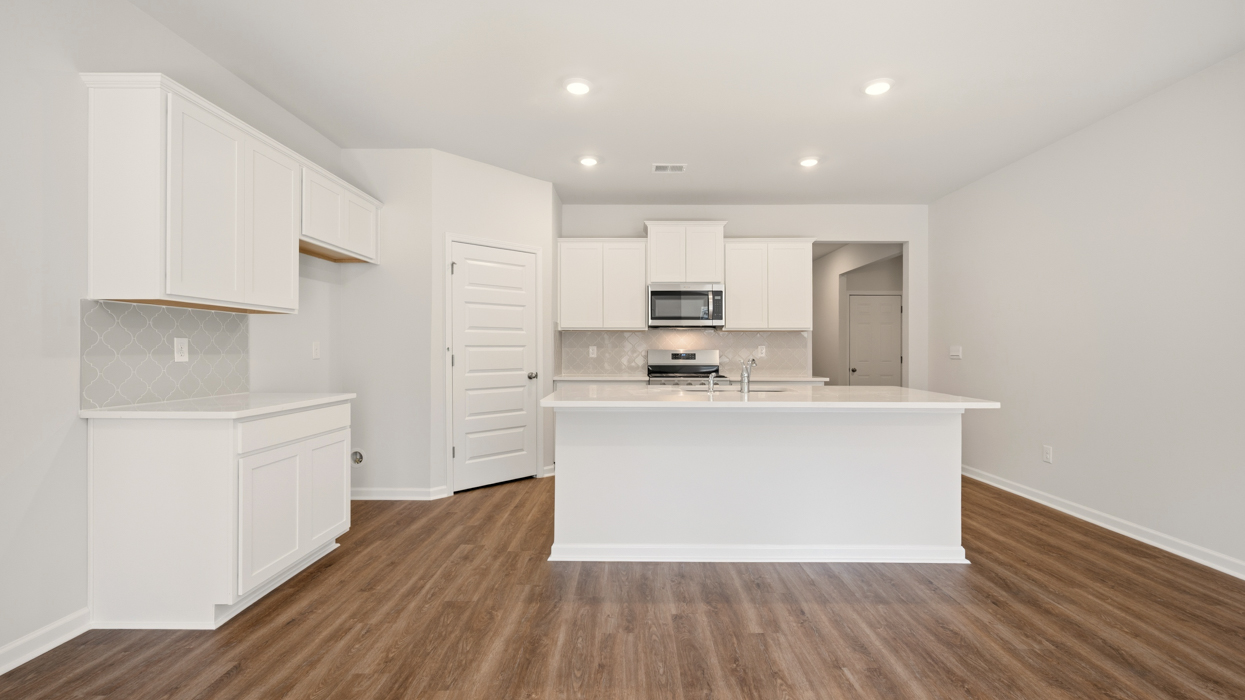 kitchen with spacious white cabinetry and large center island