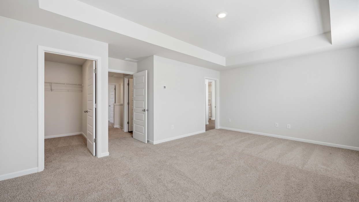 bedroom 1 with tray ceilings