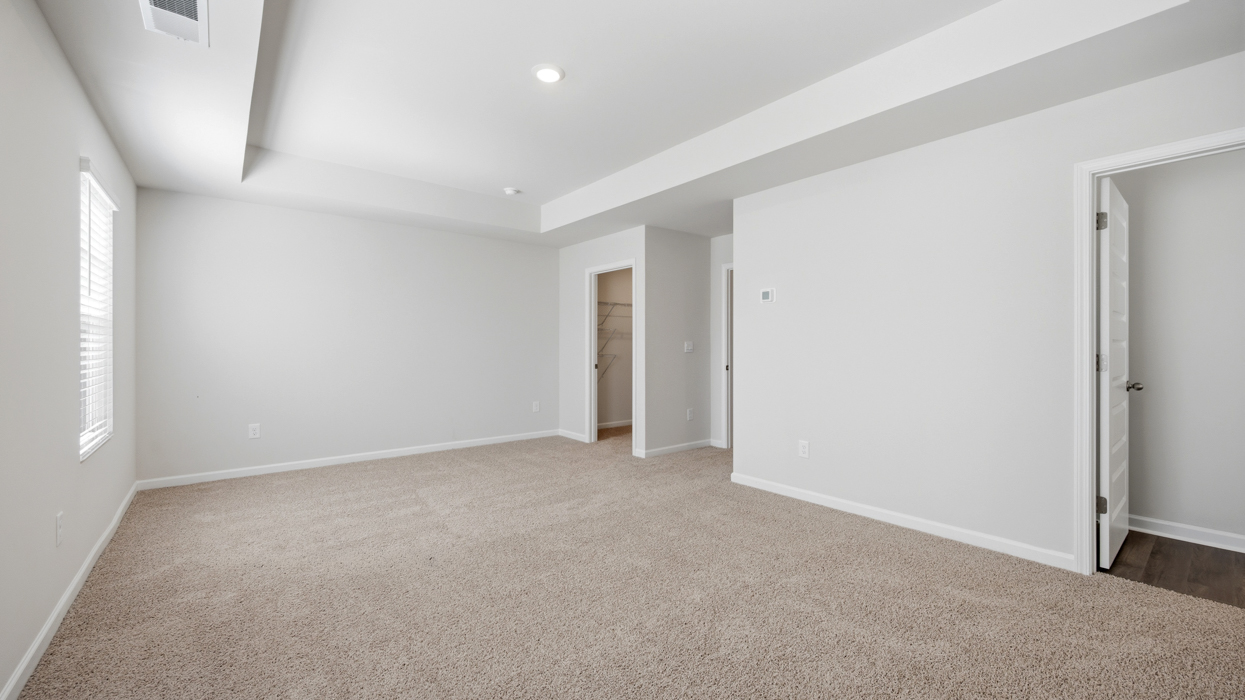bedroom 1 with tray ceilings