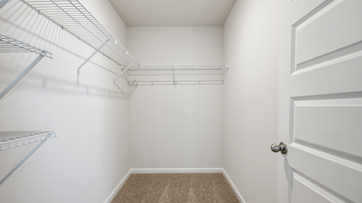 bedroom 1 closet with multiple racks
