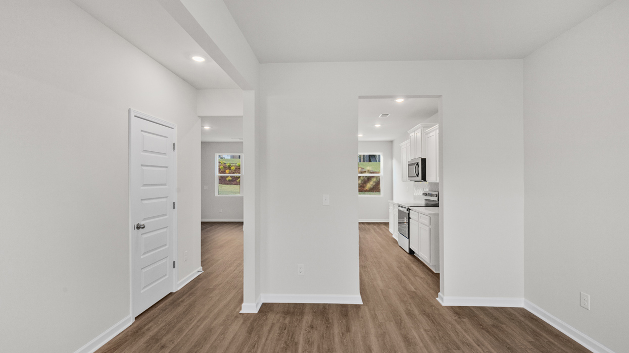 flex room view into floorplan to the kitchen and family room