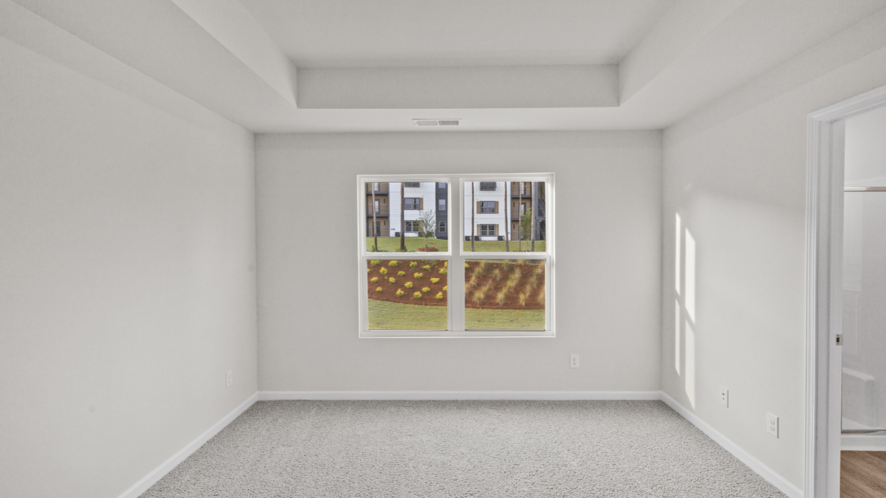bedroom 1 with tray ceilings
