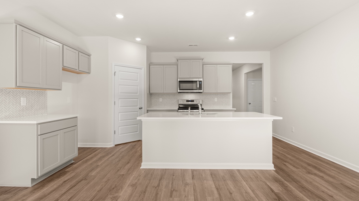 open concept kitchen with island and cabinets