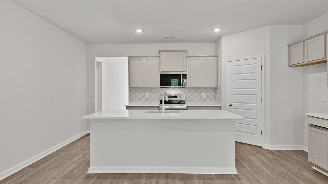 kitchen with spacious white cabinetry and large center island