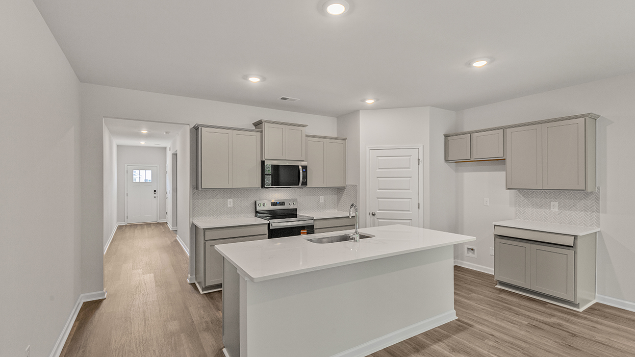 angled kitchen with spacious white cabinetry and large center island