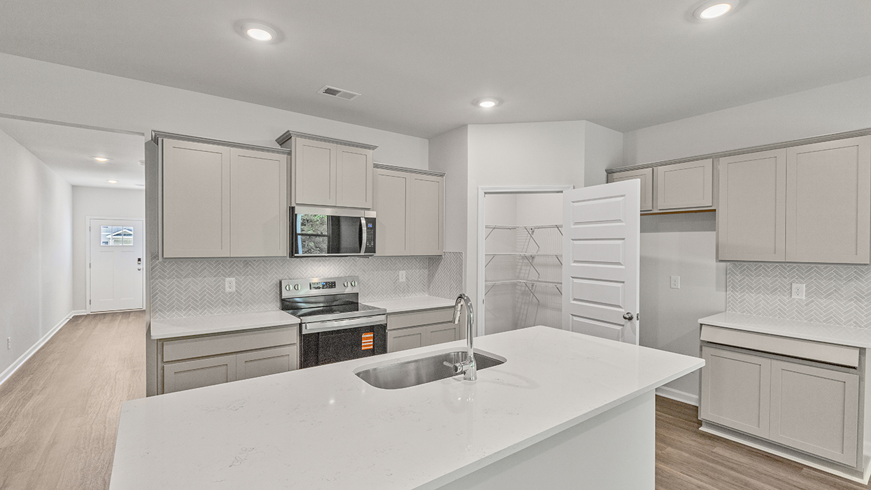 angled kitchen with spacious white cabinetry and large center island