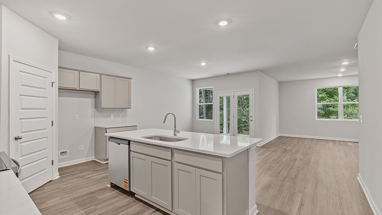angled kitchen with spacious white cabinetry and large center island