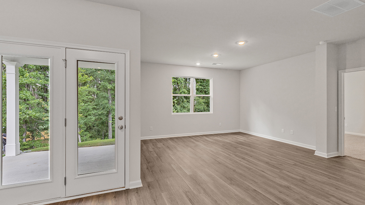breakfast room with access to rear patio and living room with natural light