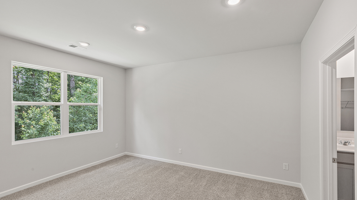 angled primary bedroom with natural light