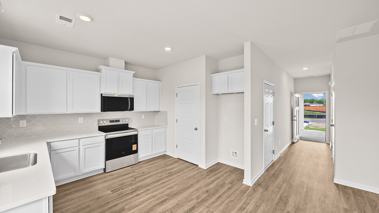 angled kitchen with spacious gray cabinetry