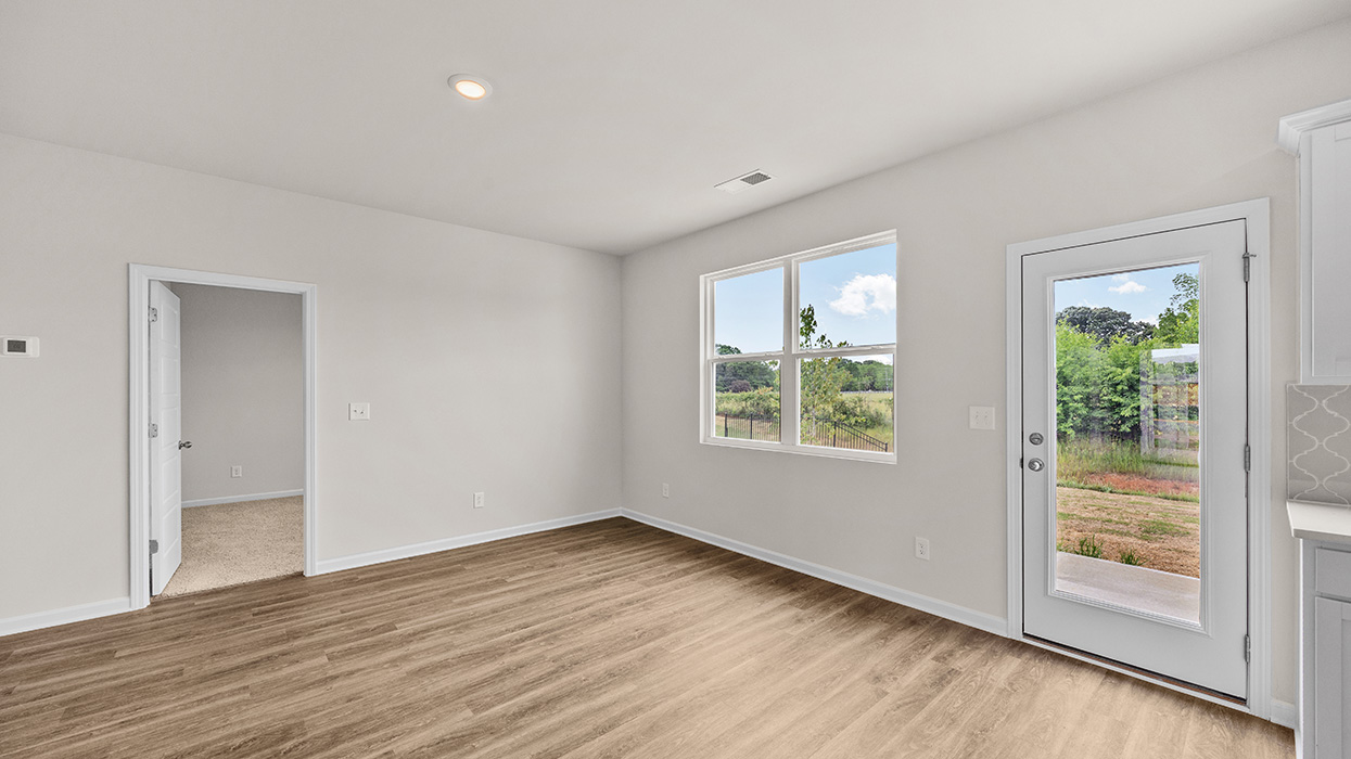 angled living room with natural light and rear patio access