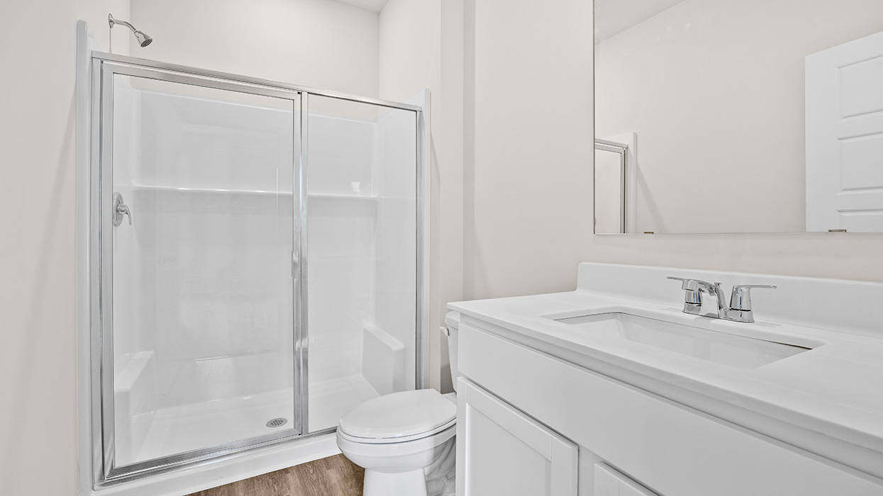 primary bathroom with single sink and walk-in shower