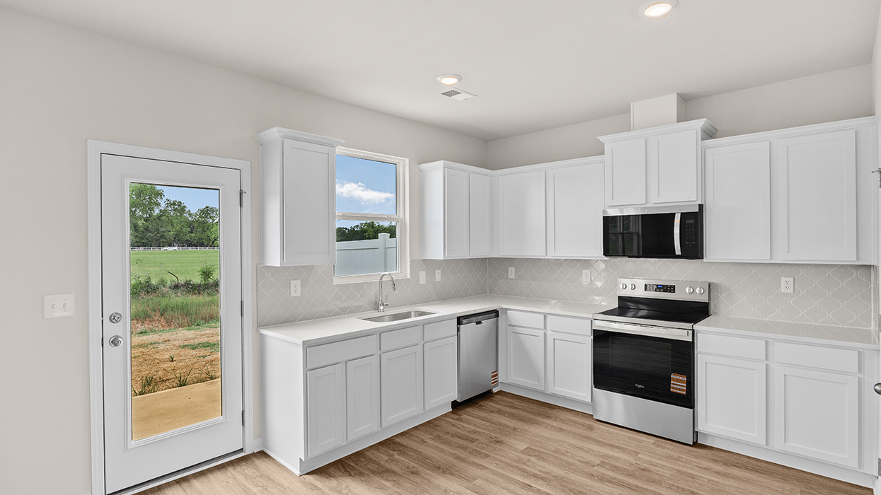 angled kitchen with spacious gray cabinetry
