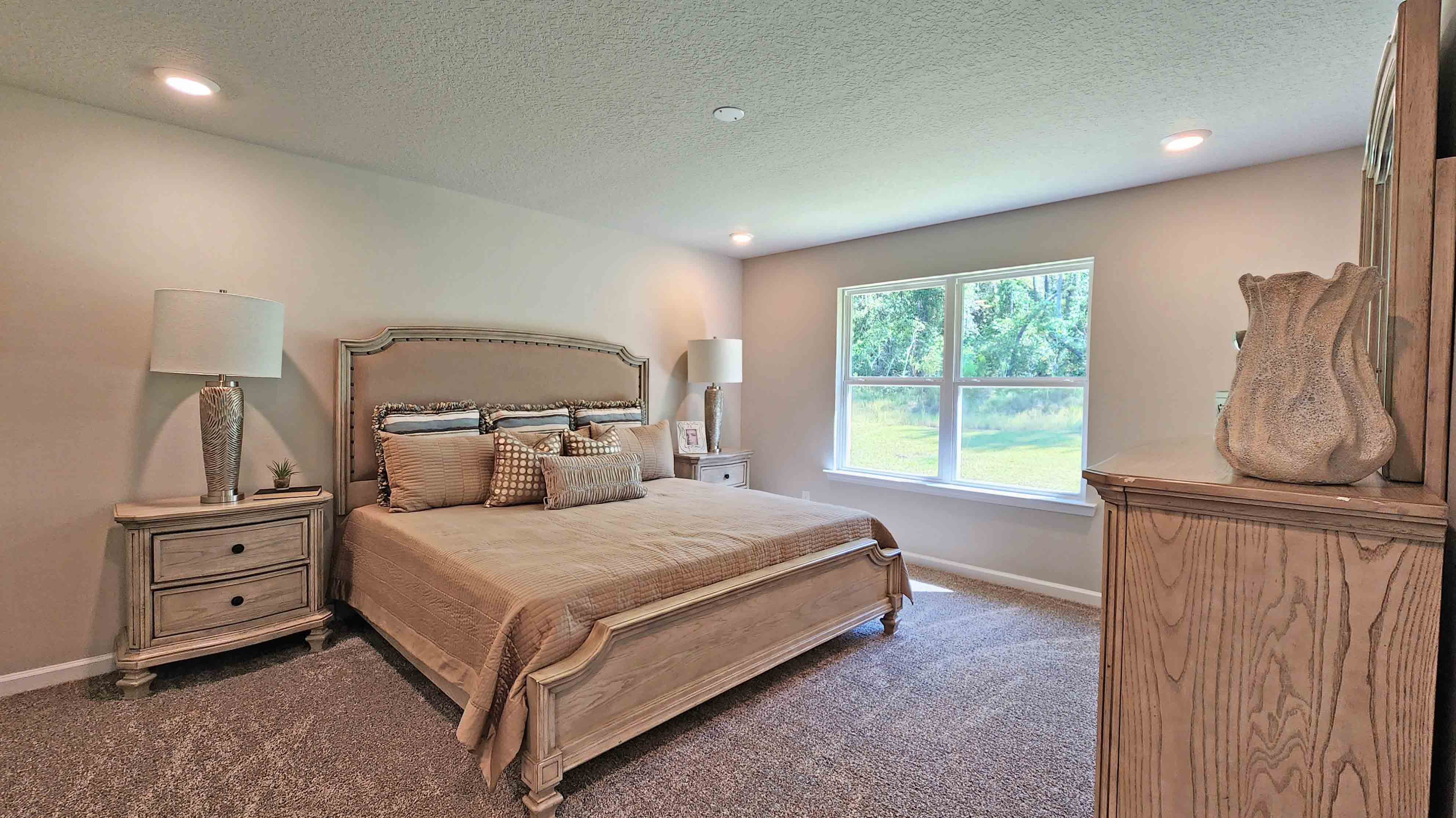 Spacious primary bedroom neutrally decorated