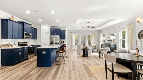 Open floorplan with a blue and white kitchen in Mobile.