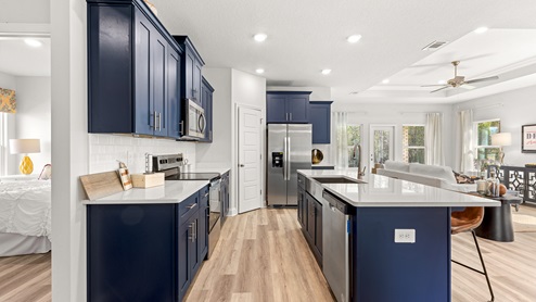 Open kitchen with navy cabinets in a new home in Mobile, AL.