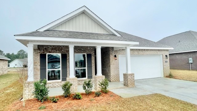 Front porch with beautiful landscaping on a new home in Mobile, AL.