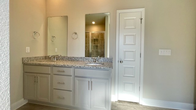Dual sink vanity with granite countertop.