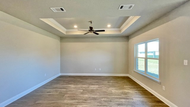 Living room with trey ceiling and large window.