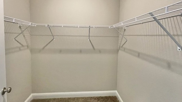 Walk-in closet with wire shelving.