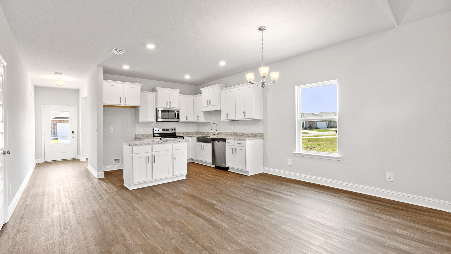 Open space with luxury vinyl plank flooring and recessed lights in Mobile, AL.