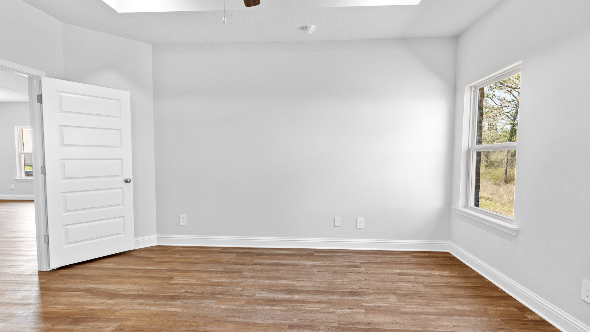 Primary suite with luxury vinyl plank flooring in a new construction home near me.