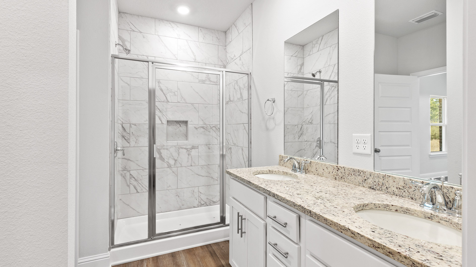Primary bath with roomy shower and spa-like elegance.