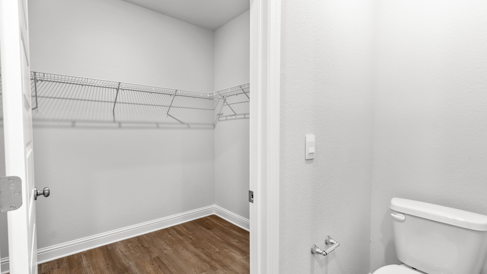 Spacious primary closet with room to store clothes and more.