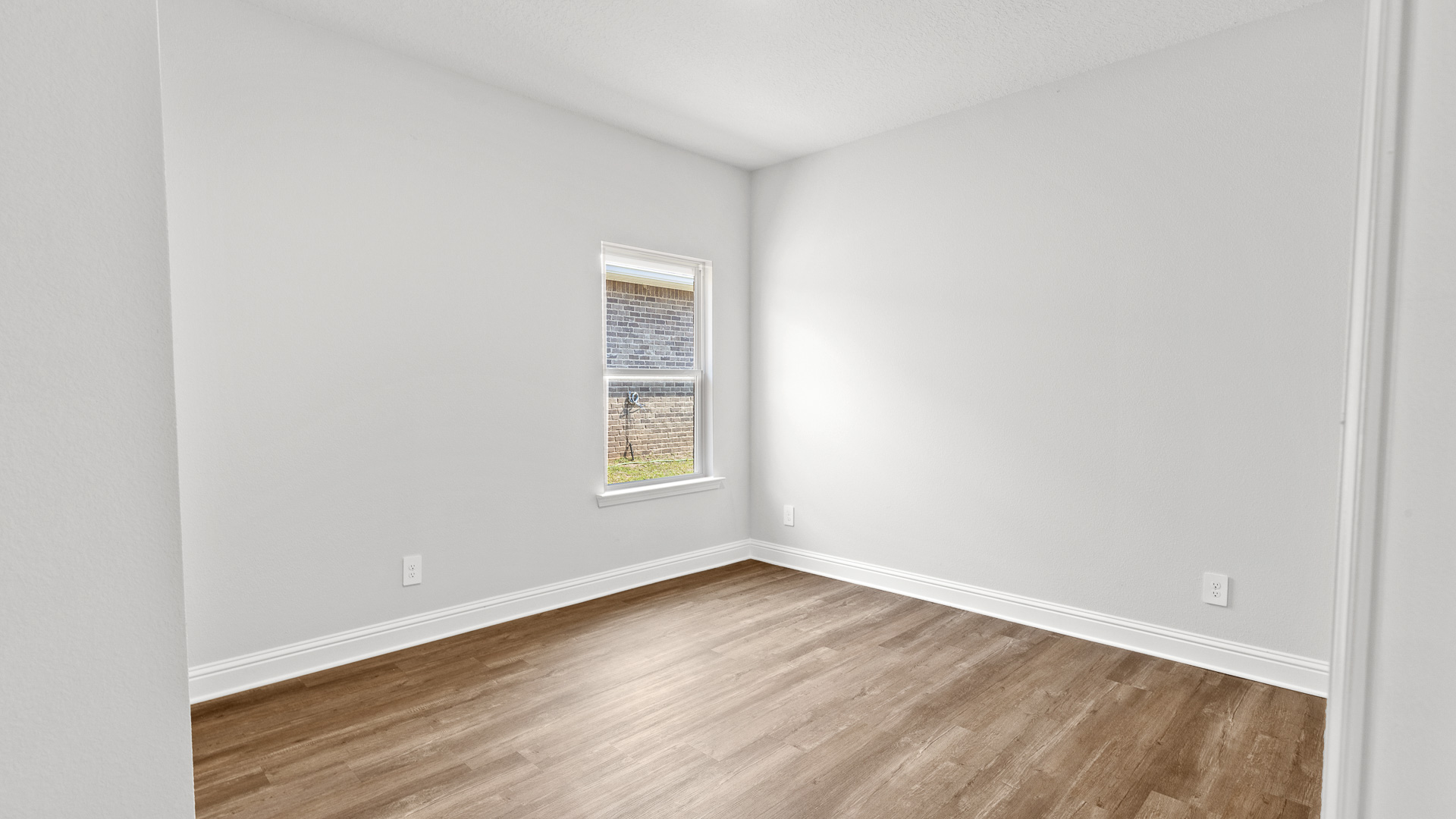 New construction home with guest bedroom that includes LVP flooring.
