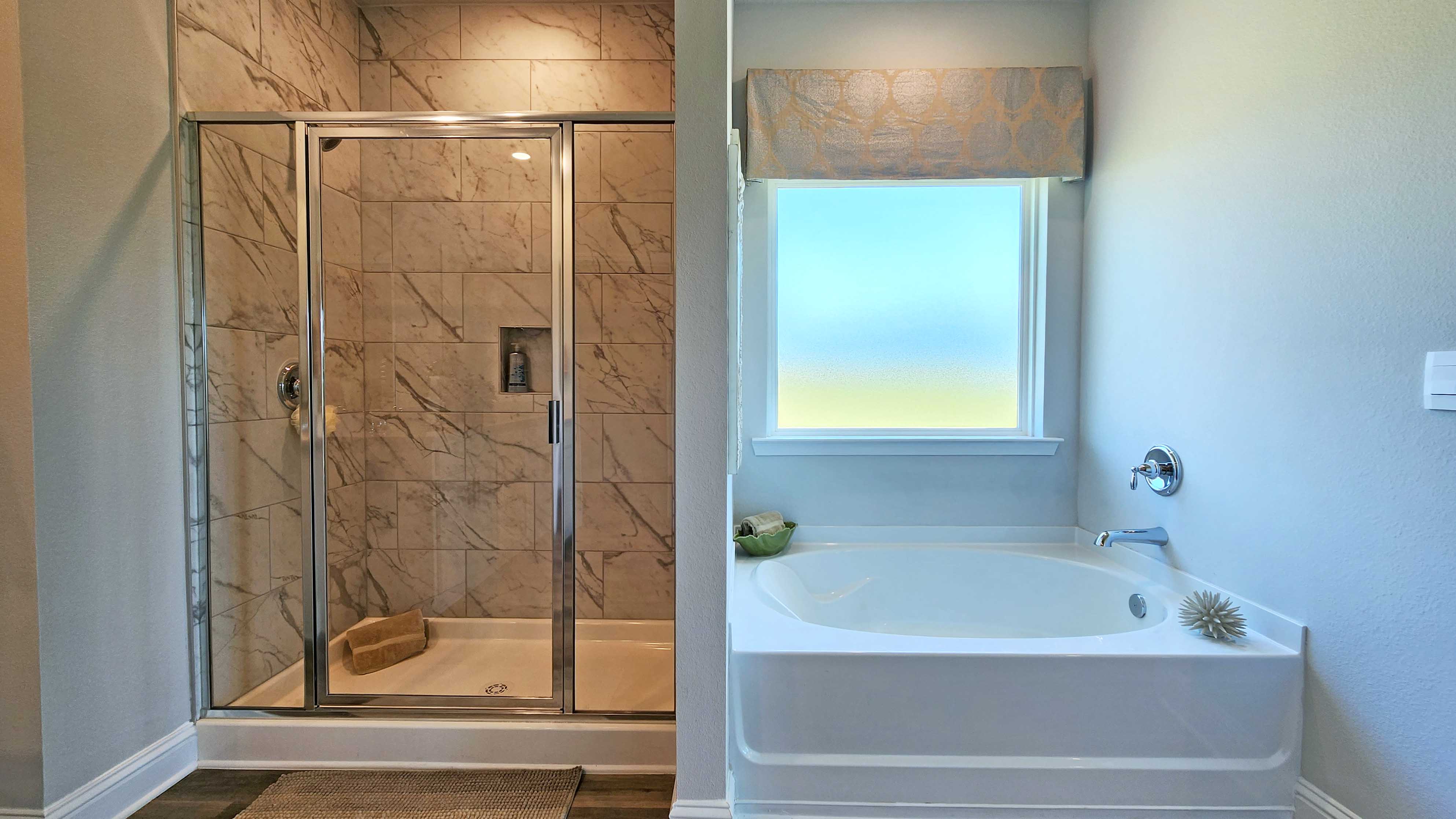 Primary bathroom with garden tub and tiled shower.