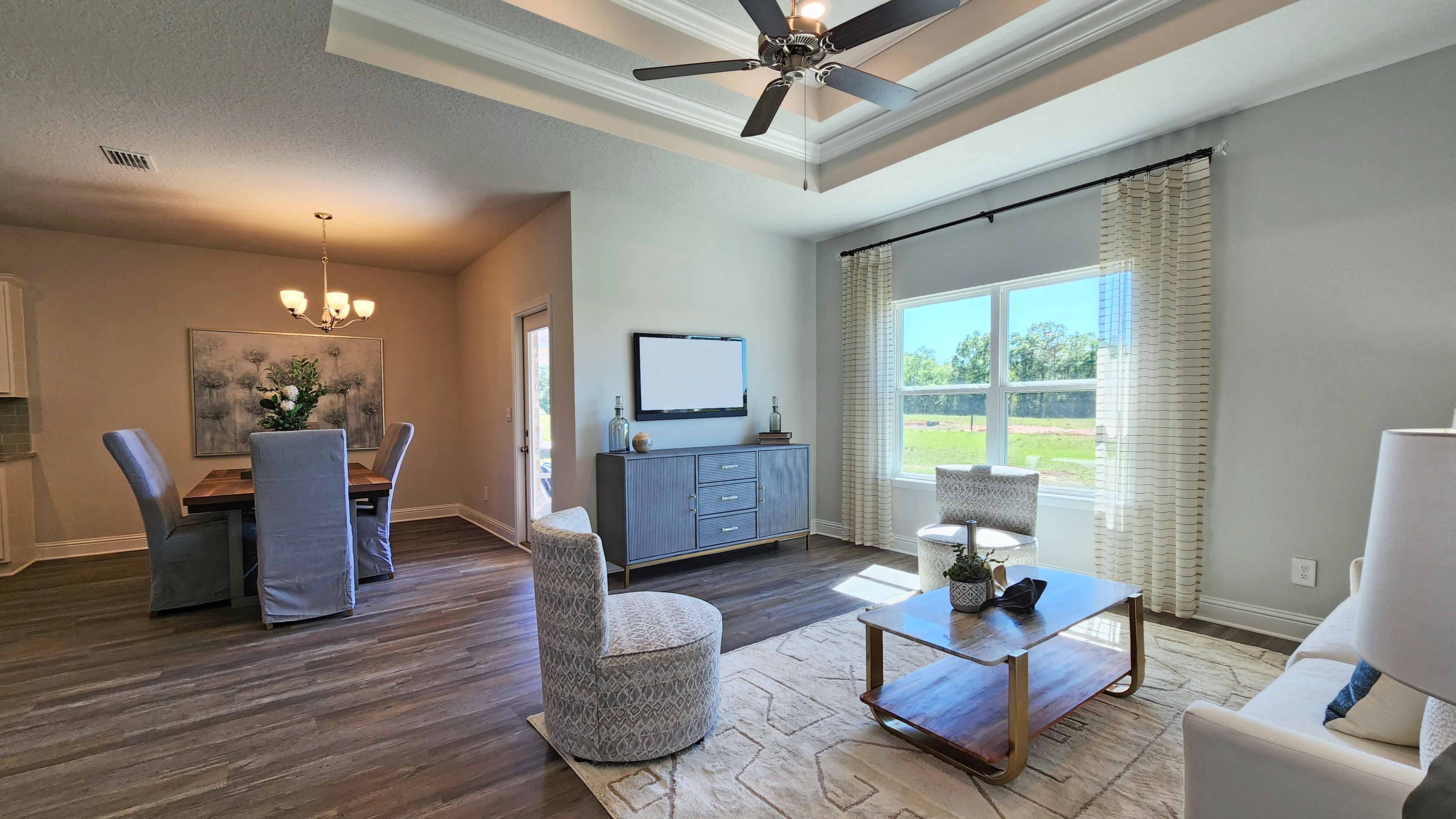 Living room area with windows offering views to back yard.