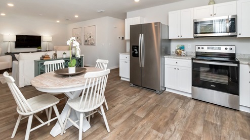 View of the open floorplan of kitchen table aside the kitchen.