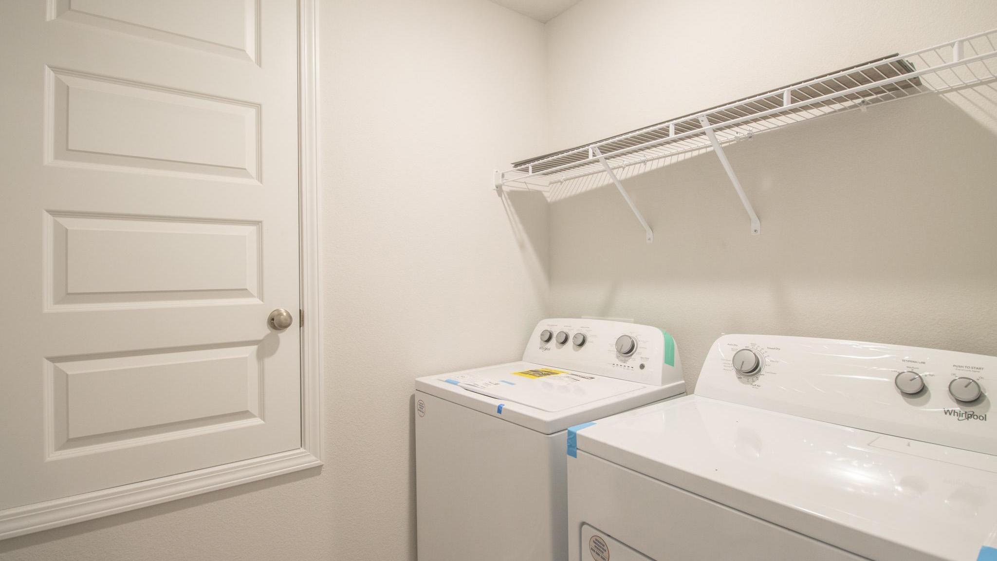 Laundry room with wire shelving.